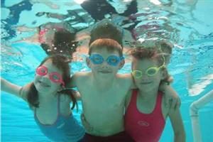 3 kids swimming