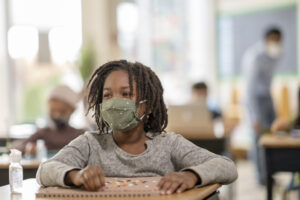 girl with mask in classroom